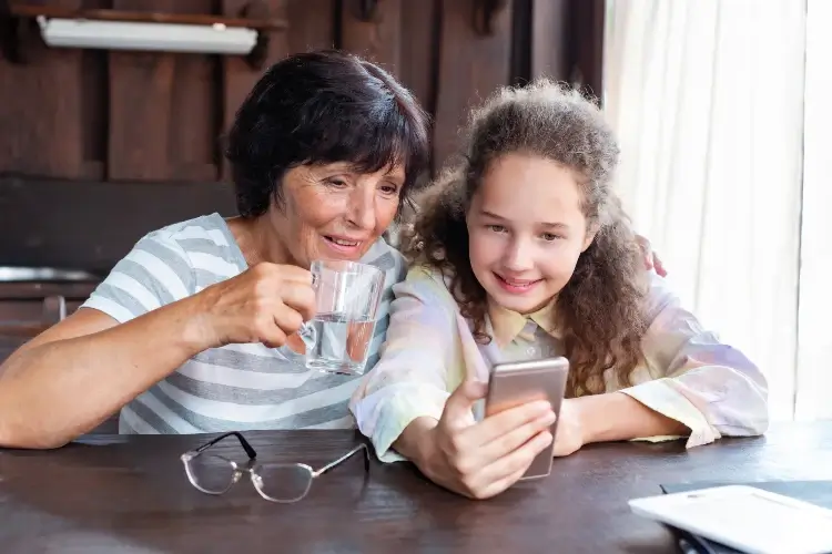 grandmother with tween girl looking at a self-one and encouraging confidence